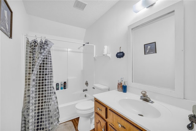 full bathroom featuring vanity, toilet, a textured ceiling, and shower / bath combo with shower curtain