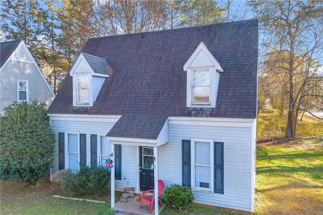 new england style home with a front lawn