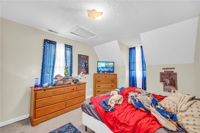 carpeted bedroom featuring vaulted ceiling and a textured ceiling