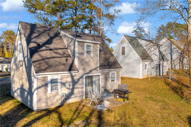 back of property with a lawn and a patio