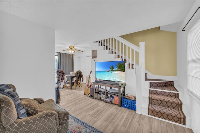 living room with hardwood / wood-style flooring and ceiling fan