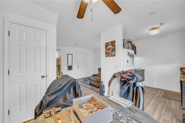 living room featuring ceiling fan and light wood-type flooring