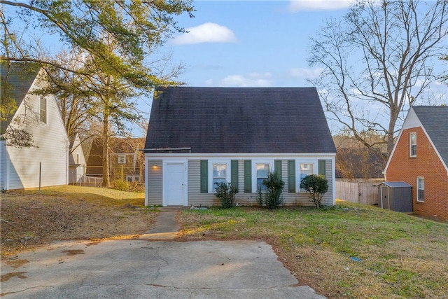 cape cod home with a front lawn