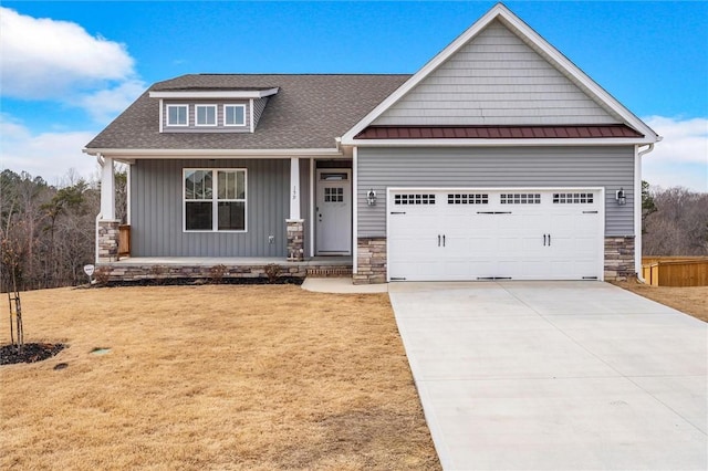 craftsman-style house with a garage, a front lawn, and covered porch