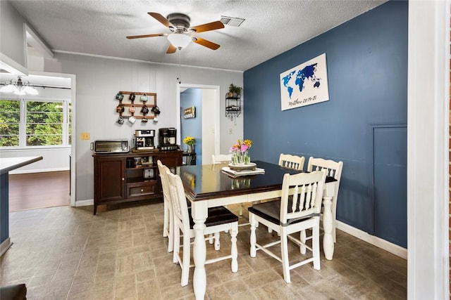 dining room featuring a textured ceiling and ceiling fan