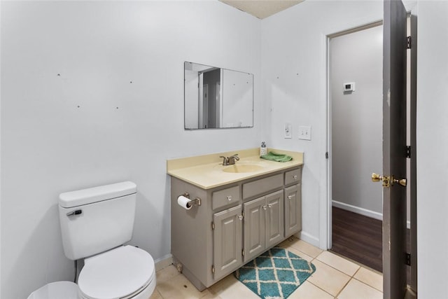 bathroom with vanity, tile patterned floors, and toilet