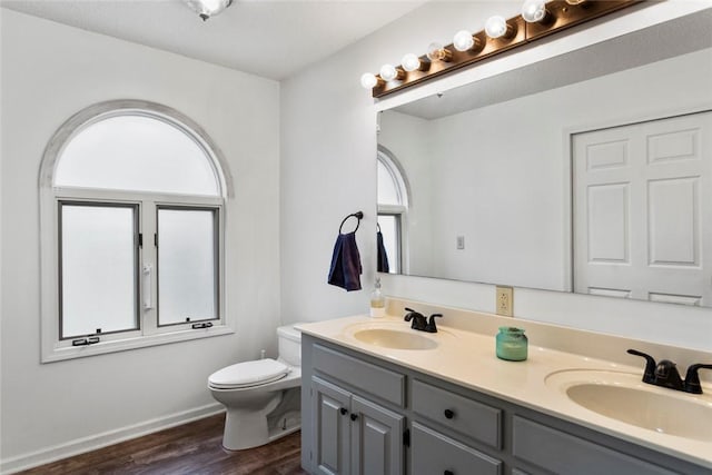 bathroom with vanity, hardwood / wood-style floors, and toilet