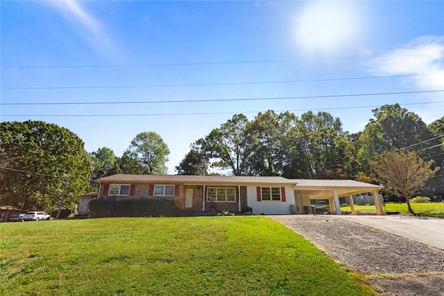 single story home with a front lawn and a carport