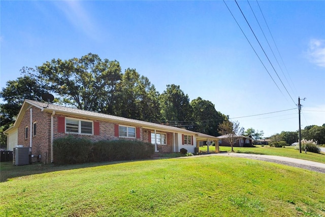 ranch-style home featuring cooling unit and a front lawn