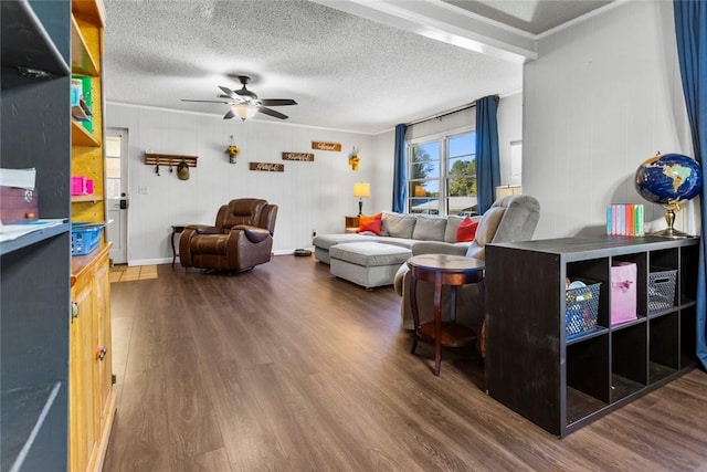 living room featuring crown molding, a textured ceiling, dark hardwood / wood-style floors, and ceiling fan