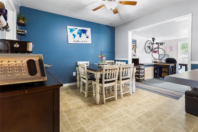 dining space with a textured ceiling and ceiling fan