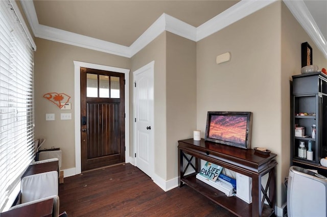 foyer entrance with crown molding and dark hardwood / wood-style floors