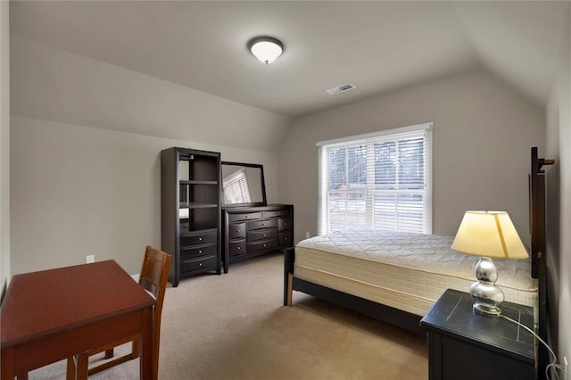 carpeted bedroom with vaulted ceiling