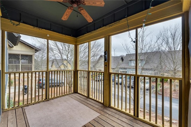 unfurnished sunroom with a wealth of natural light and ceiling fan