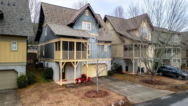 view of front of home with a garage and a sunroom