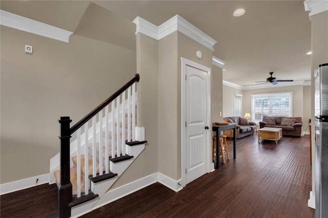 stairway with ceiling fan, ornamental molding, and hardwood / wood-style floors