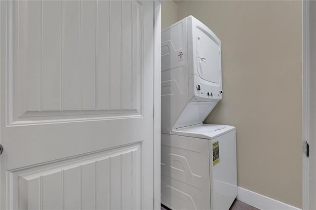 laundry room with stacked washer / drying machine