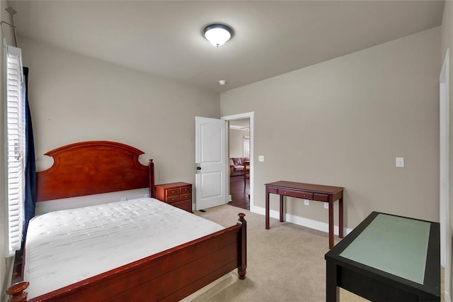 bedroom featuring light carpet