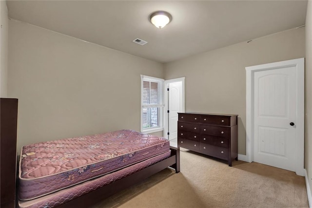 bedroom featuring light carpet