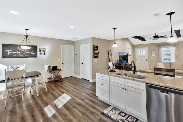 kitchen featuring pendant lighting, sink, dishwasher, light stone countertops, and white cabinets