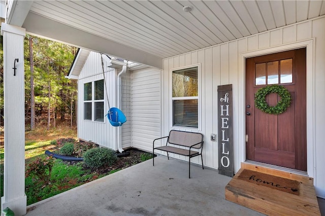 view of exterior entry with a porch