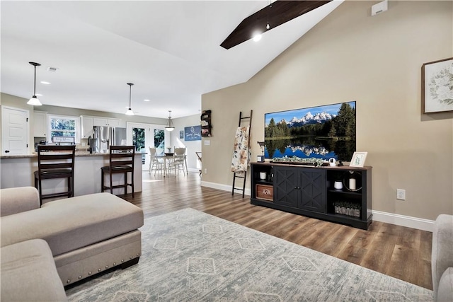 living room featuring lofted ceiling and hardwood / wood-style flooring