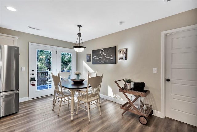 dining area with dark hardwood / wood-style flooring