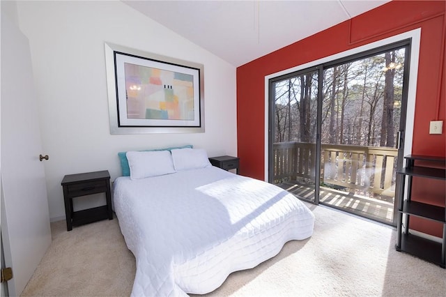 carpeted bedroom with vaulted ceiling and access to outside