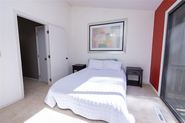 carpeted bedroom featuring lofted ceiling