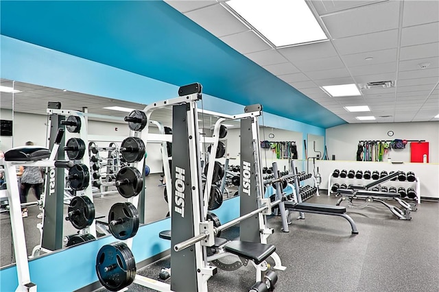 gym with a paneled ceiling