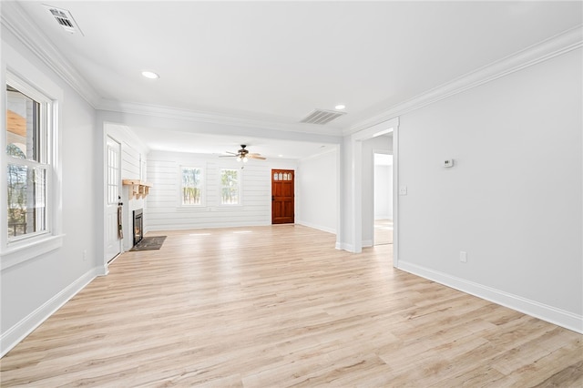 unfurnished living room featuring ornamental molding, ceiling fan, and light wood-type flooring