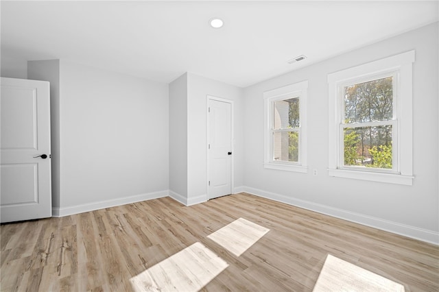 unfurnished room with light hardwood / wood-style floors