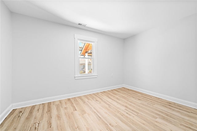 empty room with light hardwood / wood-style flooring