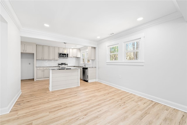 kitchen with a kitchen island, appliances with stainless steel finishes, decorative light fixtures, tasteful backsplash, and crown molding