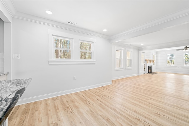 unfurnished living room featuring crown molding, light hardwood / wood-style floors, and ceiling fan