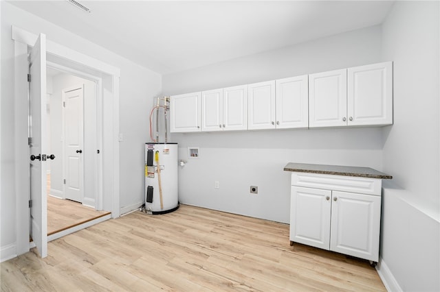 laundry area featuring hookup for a washing machine, electric water heater, hookup for an electric dryer, and light hardwood / wood-style flooring