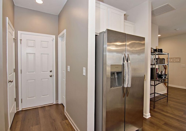 kitchen featuring stainless steel fridge with ice dispenser, dark wood-type flooring, and white cabinets