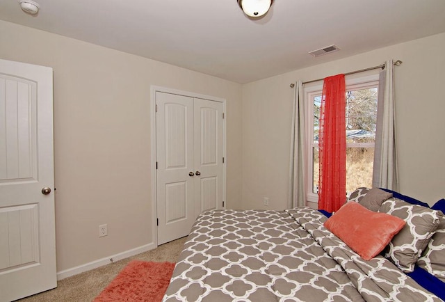 bedroom with light colored carpet and a closet