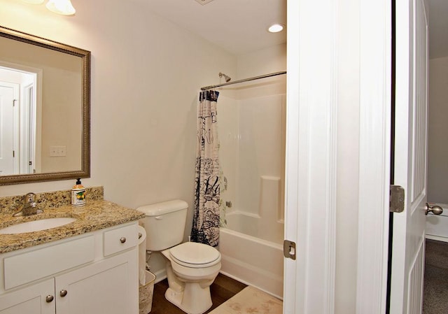 full bathroom with shower / bathtub combination with curtain, vanity, and toilet