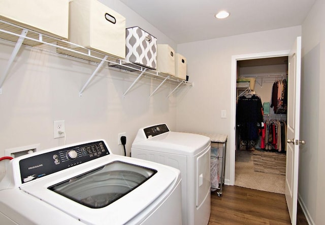 laundry room featuring washing machine and clothes dryer and dark hardwood / wood-style flooring