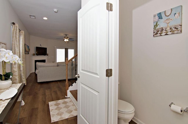 bathroom with hardwood / wood-style floors, ceiling fan, and toilet