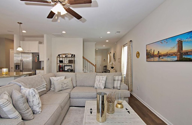 living room featuring hardwood / wood-style flooring and ceiling fan