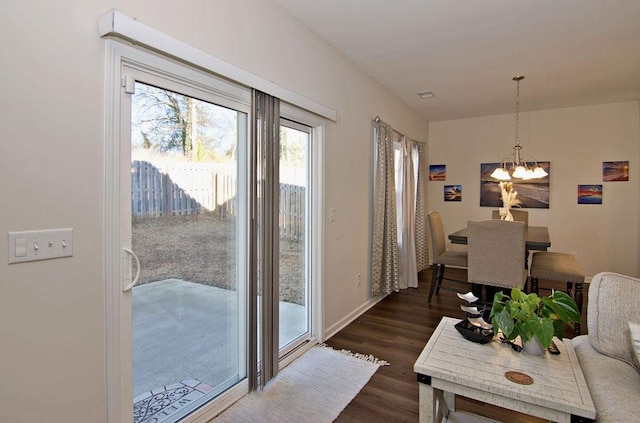 interior space with an inviting chandelier and dark hardwood / wood-style flooring