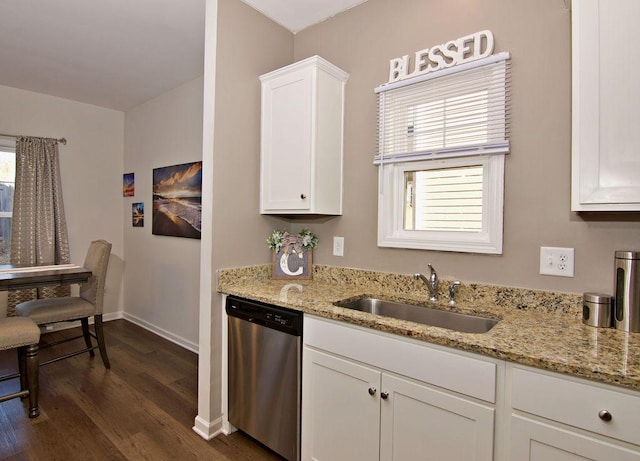 kitchen featuring dishwasher, sink, white cabinets, and light stone counters