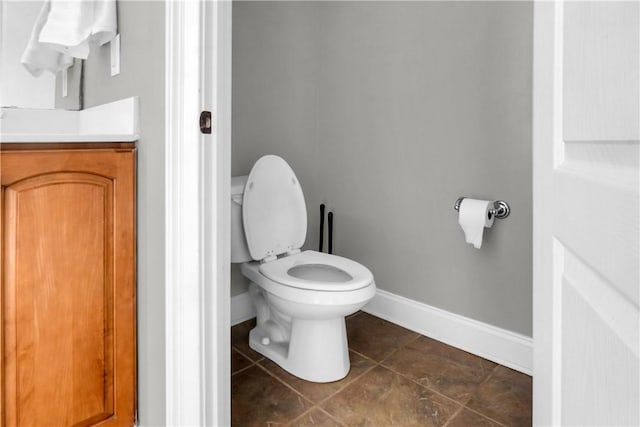 bathroom featuring vanity, tile patterned floors, and toilet