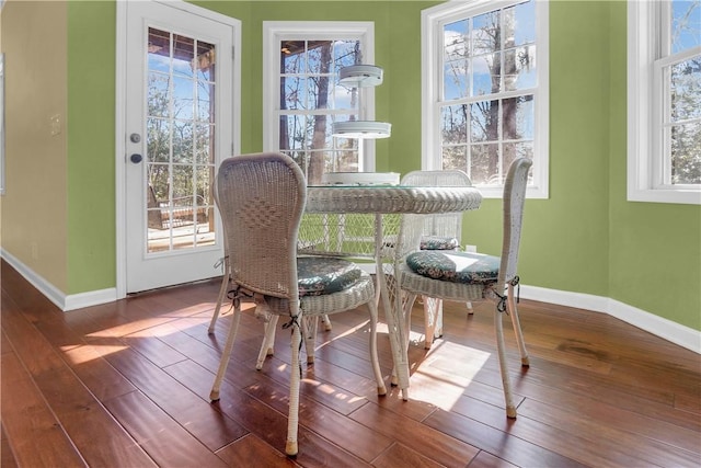 dining space with wood-type flooring