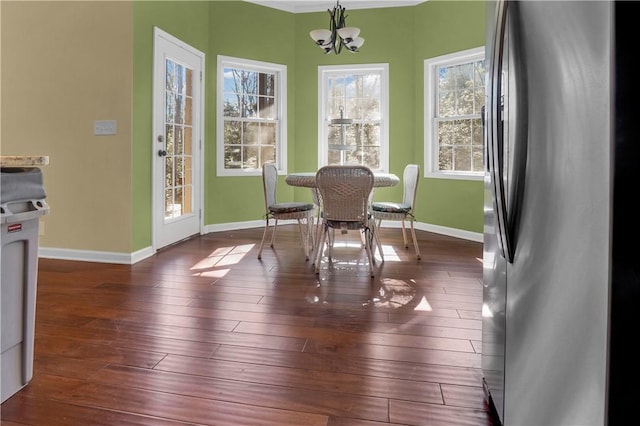 dining room featuring an inviting chandelier and dark hardwood / wood-style flooring