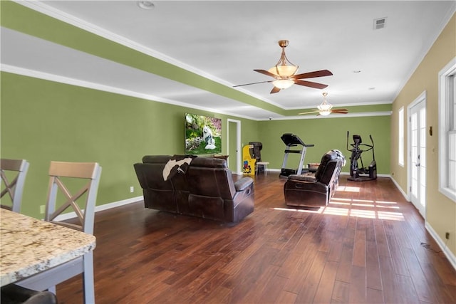 living room with crown molding, ceiling fan, dark hardwood / wood-style floors, and a raised ceiling