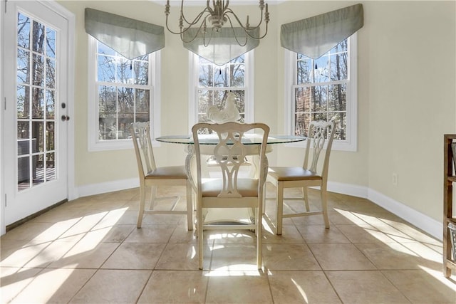 tiled dining area featuring a chandelier