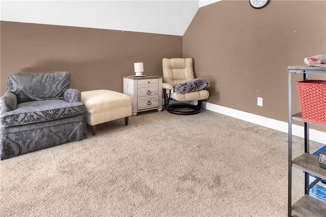 sitting room with carpet flooring and vaulted ceiling